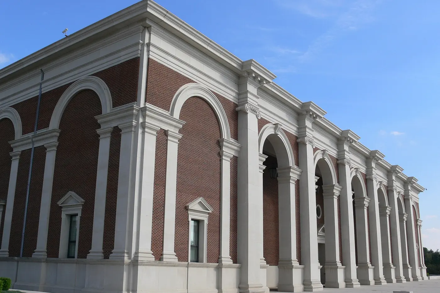 The red brick and white stone arches of the Meadows Museum at SMU